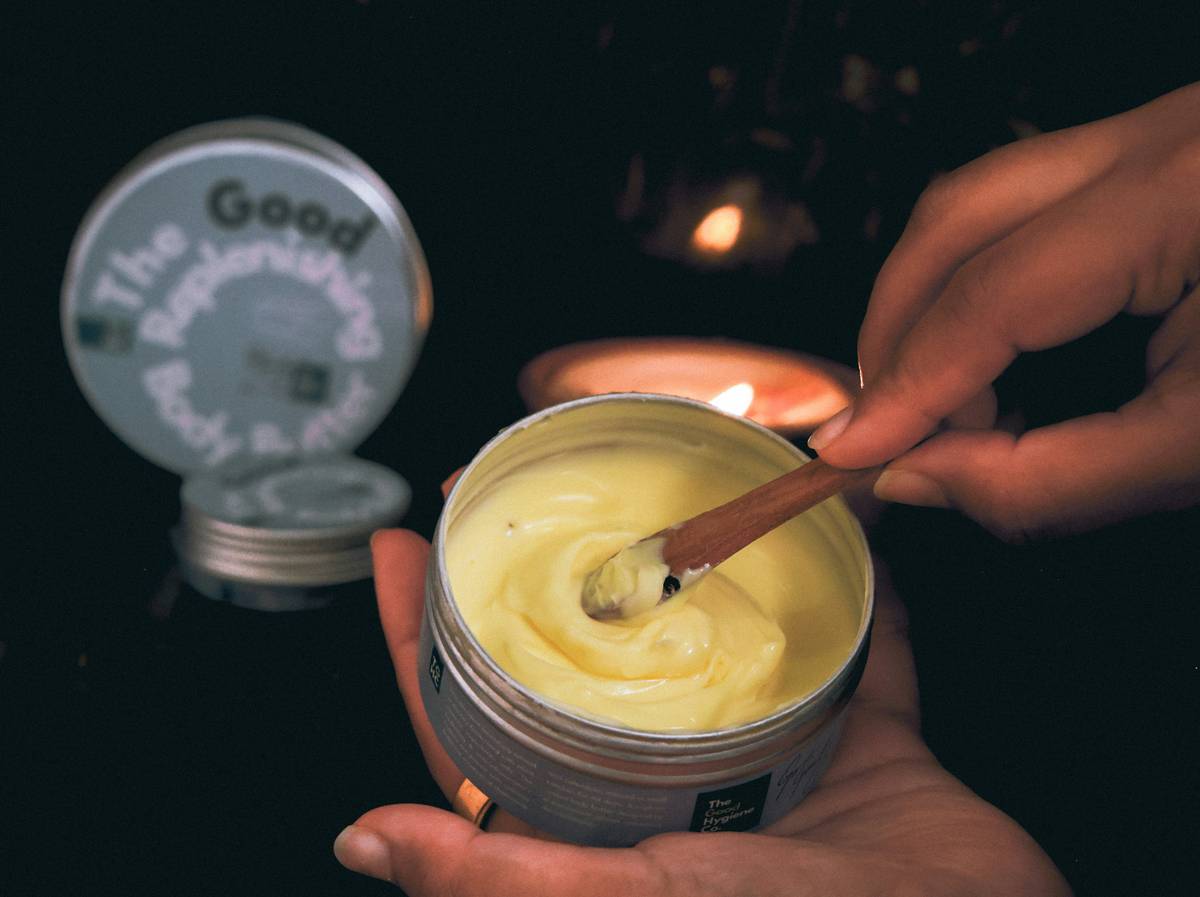 Woman applying rich moisturizer balm can you use on dry heels at home