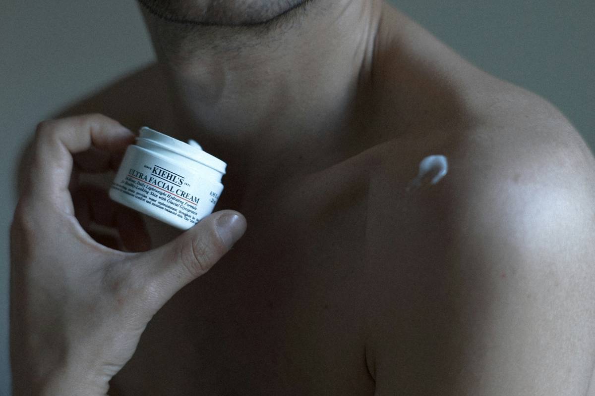 Man applying pure for men bum balm to inner thighs before workout