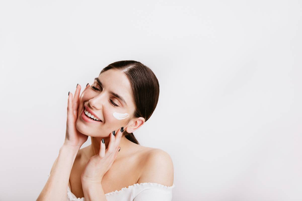 woman applying hydrating cream balm to dry elbows for deep moisture retention